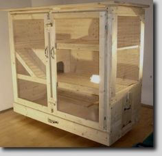 a large white cage sitting on top of a hard wood floor