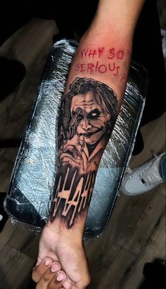 a person with a joker tattoo on their arm