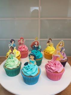 there are many cupcakes that have princess figures on them