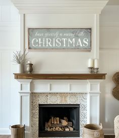 a fireplace with a christmas sign above it