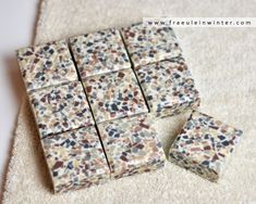 four pieces of tile sitting on top of a white rug