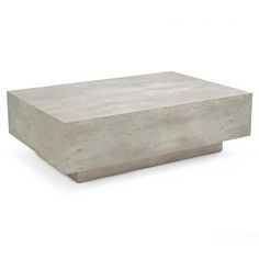 a concrete table sitting on top of a white floor