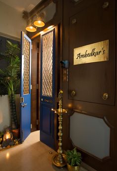 the entrance to an upscale hotel with blue doors and gold trimmings on the door