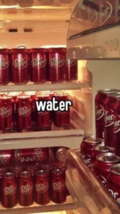 a refrigerator filled with lots of red soda