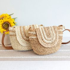 two straw bags sitting on top of a table next to a sunflower