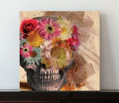 a painting of a skull with flowers in it's head on a shelf next to a wall