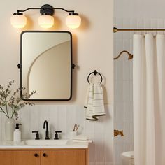 a bathroom with a sink, mirror and shower curtain in it's center area