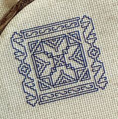 a close up of a cross stitch pattern