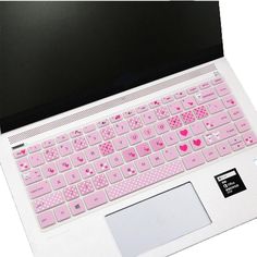 an open laptop computer sitting on top of a white surface with pink keys and hearts