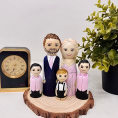 a family figurine sitting on top of a tree stump next to a clock