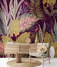 a living room with purple and green wallpaper, a chair and table in front of it