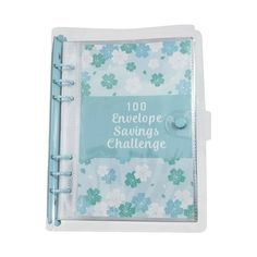 a blue and white notebook with flowers on the cover, that reads 100 envelope savings challenge