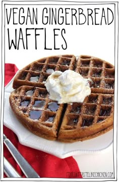 a plate with waffles and whipped cream sitting on it next to a fork