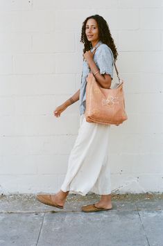 DIMENSION Oversized tote, dimensions vary COLOR Peach, orangey-pink MATERIAL Cactus silk, cotton lining, natural leather strap Orange Everyday Bag For Spring, Orange Shoulder Bag For Everyday Spring Use, Orange Shoulder Bag With Adjustable Strap For Spring, Bohemian Orange Bags For Spring, Ethically Sourced Bags For Vacation, Orange Bohemian Bags For Spring, Orange Cotton Shoulder Bag For Everyday Use, Summer Brown Shoulder Bag With Canvas Lining, Casual Orange Cotton Shoulder Bag