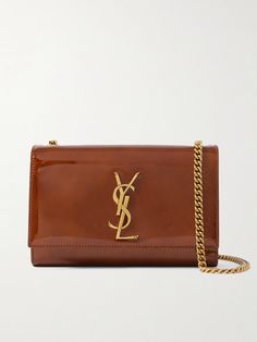 SAINT LAURENT's 'Kate' bag has been made in Italy from glossy patent-leather that's punctuated with the label's iconic 'YSL' logo plaque. This compact style is sized to fit all the essentials and has a sliding chain strap that can either be worn on your shoulder or cross-body - tuck it away to carry yours as a clutch.<br><br>Lower-Impact Materials. This product is made using at least 50% lower-impact materials or ingredients. Find out more about our NET SUSTAIN criteria <a href="https://www.net-a-porter.com/en-gb/campaigns/net-sustain">here.</a> Ysl Kate Taupe, Luxury Leather Shoulder Bag With Glossy Finish, Designer Patent Leather Bag With Glossy Finish, Luxury Patent Leather Bags For Formal Occasions, Luxury Bags With Glossy Finish For Formal Occasions, Luxury Glossy Formal Bags, Luxury Glossy Finish Formal Bags, Luxury Glossy Finish Shoulder Bag, Elegant Patent Leather Bag With Glossy Finish