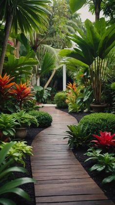 a wooden walkway surrounded by tropical plants and trees