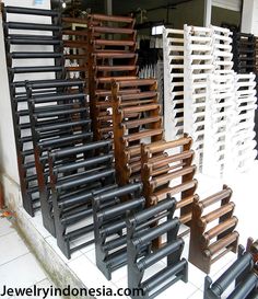 there are many wooden chairs lined up on the floor in front of a store window