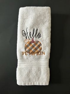 a white towel with the word hello pumpkin embroidered on it