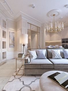 a living room filled with furniture and a chandelier