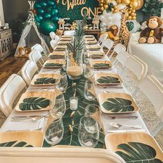 a table set up for a jungle themed birthday party