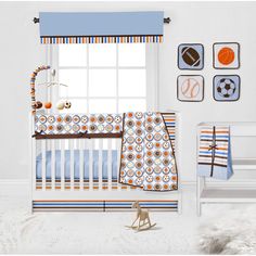 a baby's room is decorated in blue, orange and white with sports themed wall hangings