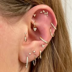 a woman wearing ear piercings with diamonds