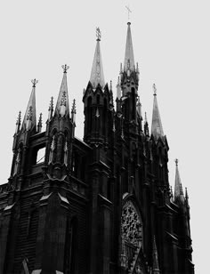 an old church with steeples and clocks on it's front spires is shown in black and white