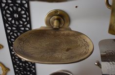 an ornate brass sink hanging from the wall