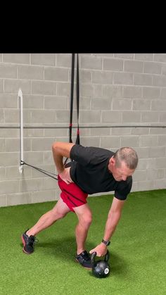 a man is doing exercises on the grass