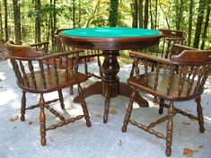 a table with four chairs around it in the woods