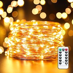 a close up of a string of lights on a table next to a remote control