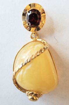 Pendant Details Stone : Butterscotch Amber and Garnet designer pendant 925. Metal : 925 Sterling Silver with Gold plated. Length: Approx. 2 inches (please refer to the picture) width : Approx. 1 inches.( please refer to the picture) weight : 20.30 Grams.(please refer to the picture) color : yellow  Geologically, amber has been documented throughout the world (figure 8), with most deposits found in Tertiary-period sediments dating to the Eocene, a few to the Oligocene and Miocene, and fewer still to later in the Tertiary. Amber is formed from resin exuded from tree bark (figure 9), although it is also produced in the heartwood. Resin protects trees by blocking gaps in the bark. Once resin covers a gash or break caused by chewing insects, it hardens and forms a seal. Resin's antiseptic prope Oval Baltic Amber Gold Jewelry, Amber Large Pendant Necklace For Formal Occasions, Formal Amber Necklace With Large Pendant, Amber Necklace With Large Pendant For Formal Occasions, Classic Amber Pendant Jewelry, Classic Baltic Amber Gold Jewelry, Classic Gold Jewelry With Baltic Amber, Classic Formal Jewelry With Baltic Amber, Classic Formal Jewelry In Baltic Amber