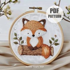 an embroidered fox is sitting on a log