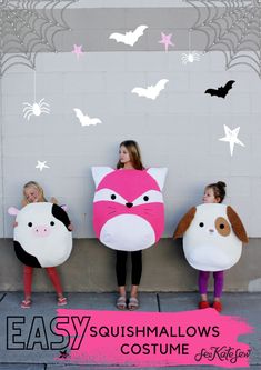 three girls wearing costumes made to look like animals