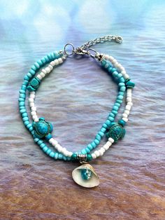 🌴Tropical paradise! 🌺 This handmade aqua and white matte seed bead ankle bracelet, with turquoise turtle bead charms and turquoise stones will give you that feel of the tropics! Makes a lovely gift for your special someone or keep as a "Me Day" beach accessory! Sea turtles symbolizes longevity, peace, grounding, ancient wisdom, and emotional strength.  The anklet measures 10 inches long with the silver plated 2-inch extender.  I will gladly adjust the size of the anklet for a customized fit. Please follow the steps on the chart in the photos to measure your ankle or measure your favorite anklet, then send me a message with your desired size. Please measure your ankle before ordering as I do not offer returns or exchanges for resizing MEASURING: These anklets are made on strong string mak Anklet With Charms, Seed Bead Anklet, Florida Vibes, Bracelets Summer, Turquoise Anklet, Kenosha Wisconsin, Bead Anklet, Beaded Ankle Bracelets, Tropical Jewelry