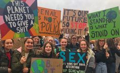 a group of people holding up signs in protest