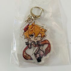 a plastic keychain with an anime character on it