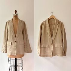 90s tailored blazer oversized /relaxed fit  natural linen blazer  unlined  single button  front hip pockets long notched collar nicely tailored relaxed/box cut Excellent condition Approx size medium/large- oversized Shoulders-16 lay flat inches Bust- 40 inches Waist-40 inches length- 27.5 inches sleeve length-25 inches no label-9removed),  stitching looks finely tailored, quality piece pockets still have their tailor stitching, unused Casual Single Button Linen Blazer, Linen Blazer With Pockets And Flat Front, Casual Linen Single Button Blazer, Neutral Summer Blazer With Notch Lapel, Casual Linen Blazer With Suit Collar, Linen Single Breasted Sport Coat, Summer Neutral Blazer With Notch Lapel, Beige Linen Blazer With Lapel Collar, Linen Single Breasted Blazer With Flat Front