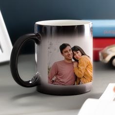 a black and white coffee mug with an image of a couple