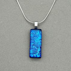 Blue Firework Dichroic fused glass Necklace with highlights of Turquoise and Green. Handmade in West Yorkshire. Please note this listing is for the necklace only. Matching earrings available here; https://jadetapsonglass.etsy.com/listing/1715164393 All pendants are handmade and unique, therefore patterns and colours may differ from the images shown. Dichroic glass has a transmitted colour and a completely different reflective colour; these two colours shift depending on the angle of view. This p Blue Fireworks, Fused Glass Necklace, Bolt Ring, Glass Jewellery, West Yorkshire, Sunderland, Dichroic Glass, 925 Jewelry, Polish Jewelry