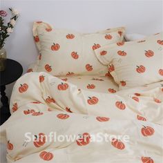 an image of a bed with pumpkins on the comforter and pillows in it