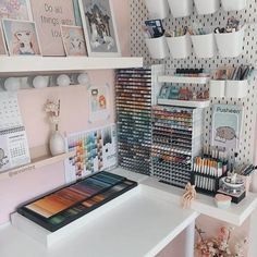 a white desk topped with lots of art supplies