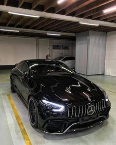 a black sports car parked in a parking garage