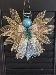 a door hanger made out of burlock and twine with a blue ornament hanging from it