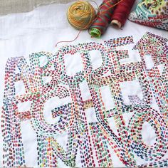 a close up of a piece of cloth with yarn on it and some balls of thread