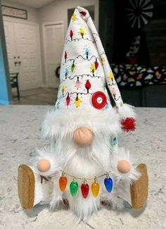 a white gnome doll sitting on top of a table