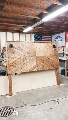 an unfinished wooden sign in a garage