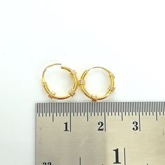 Bali style sterling silver ear hoops plated in real gold. Dimensions: 1.2 x 10 mm Price listed is for ONE PAIR of ear hoops. These are made of 925 hypoallergenic sterling silver plated with gold. Most of my pieces come with a 925 stamp. Can be packaged in a gift box. I can include a personal message from you if needed You are welcome to contact me at... bhavnakwintra1956@gmail.com For more beautiful pieces from my shop, please browse 👇 TOE RINGS: https://www.etsy.com/your/shops/TheSilverGame/to Handmade Small Hoop Gold Nose Rings, Handmade Gold Small Hoop Nose Rings, Wire Wrapped Yellow Gold Hoop Earrings, Handmade Gold Hoop Septum Ring, Handmade Gold Hoop Nose Rings, Minimalist Wire Wrapped Yellow Gold Hoop Earrings, Minimalist Yellow Gold Wire Wrapped Hoop Earrings, Nickel-free Small Hoop Gold Cartilage Earrings, Gold Nickel-free Small Hoop Cartilage Earrings