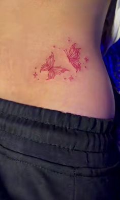 a woman's stomach with a small butterfly tattoo on her lower back and side