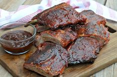 barbecue ribs on a cutting board with bbq sauce